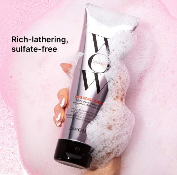 Shampoo bottle with lather on a pink background, labeled 'Rich-lathering, sulfate-free'.